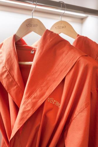 an orange shirt and tie hanging on a rack at v3rso Jardins in Sao Paulo