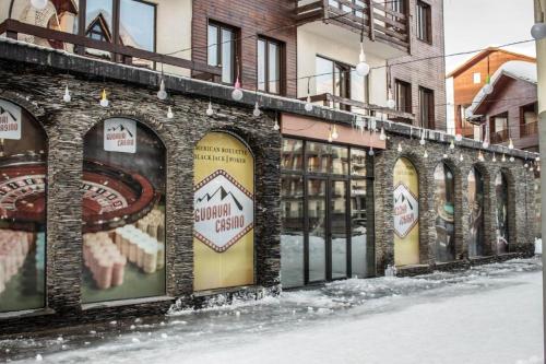 a brick building with signs on the side of it at New Gudauri Loft #1,Room 411, 412 in Gudauri