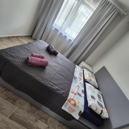 a bedroom with a bed with a purple blanket and pillows at Studio Palaz in Constanţa