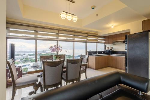 a kitchen and dining room with a table and chairs at The Radiance Manila Bay in Manila
