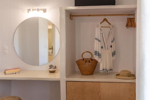 a dressing room with a mirror and a towel at Aphrodite's Child Milos Maisonette in Adamantas