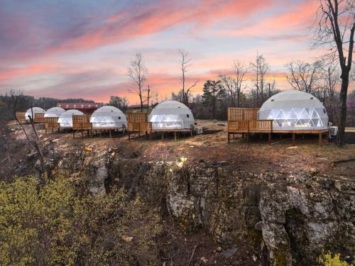a row of domes in a field at sunset at "Cardinal Crest" - The Overlook LUX Dome - RRG in Stanton