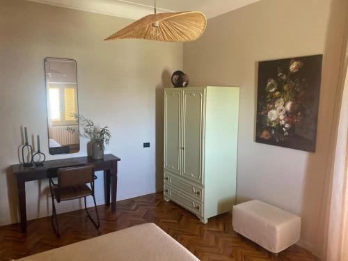 a bedroom with a desk and a green cabinet and a table at Casa Amrita B&B in Teramo