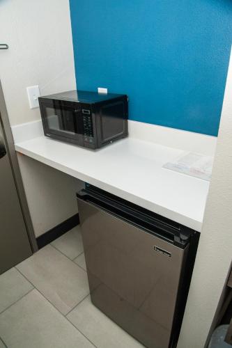 a microwave sitting on top of a counter at Holiday Inn Express Tucson-Airport by IHG in Tucson