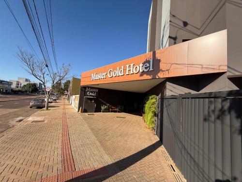 a building with a sign that reads master gold hotel at Master Gold Hotel Express in Cascavel