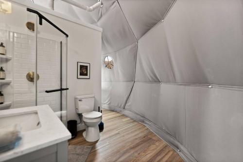a white bathroom with a toilet and a sink at "Pineview Peak" The Overlook LUX Dome - RRG in Stanton