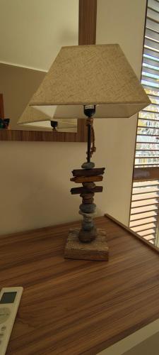 a lamp sitting on top of a wooden table at Tra mare e collina in Condrò
