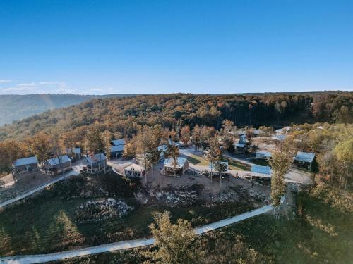 an aerial view of a home in the woods at Hoot Owl with a private hot tub in Bryant