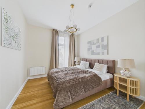 a bedroom with a bed and a window at K1820 Family apartments in Rīga