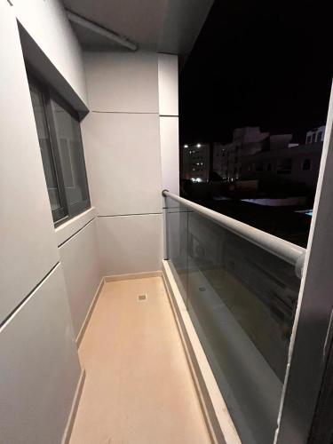 a balcony with a view of a city at night at Aryaf Hotel Apart Tabasum Group in Ajman 