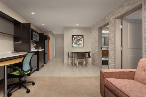 a living room with a couch and a table at Home2 Suites by Hilton Huntsville Research Park Area, AL in Huntsville