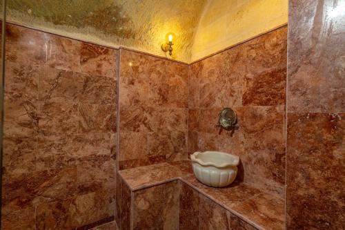 a bathroom with a shower with a toilet in it at Lagoon Cave Suites in Urgup