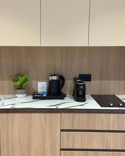 a kitchen counter with a coffee maker and a toaster at Hotel Ponta Plaza Conference & Spa in Budva