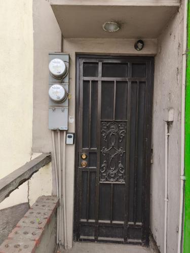 a black door on the side of a building at Don Cruz Places in Ensenada