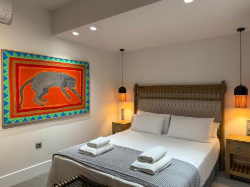 a bedroom with a bed with two towels on it at Dimeli - Sea View Villas in Foinikounta in Finikounta