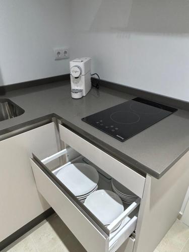 a kitchen with a sink and a stove top oven at Casa Cuatro Esquinas in Utrera