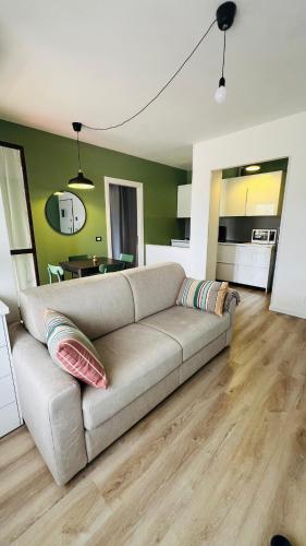 a living room with a couch and a kitchen at La Dimora di Borgo in Borgo San Dalmazzo