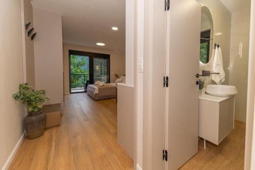 a bathroom with a sink and a toilet in a room at Villa Teona KotorBay Residence in Kotor