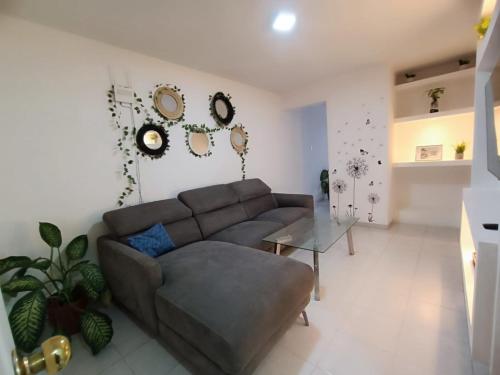 a living room with a couch and a table at Vertice in San Luis Potosí