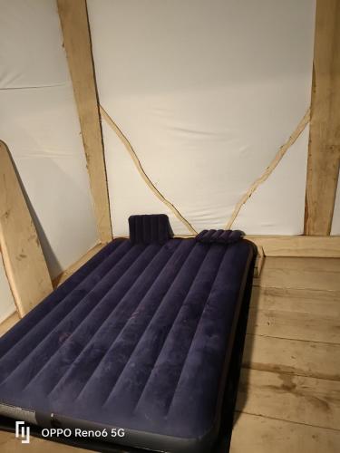a mattress is tied to a wall in a room at tipy 2 in La Celle-sous-Gouzon