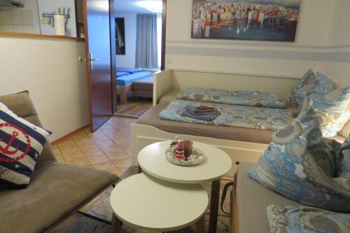 a living room with a bed and a table with a cake at Ferienwohnung mit Terrasse in Schellhorn in Schellhorn