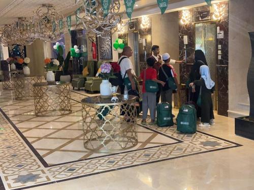 a group of people standing in a lobby at راجان للشقق المخدومة in Taif
