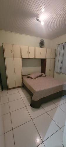 a bedroom with a bed in a room with cabinets at Terraço do Sol Apt 01 in Marcelino Ramos
