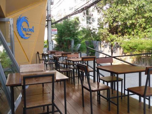 a row of tables and chairs outside a restaurant at Sea Crest by Jomtien in Jomtien Beach