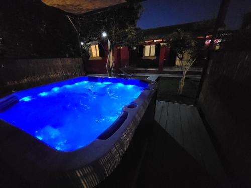 a swimming pool at night with blue lights at EMA Spa The Red house in Potámion
