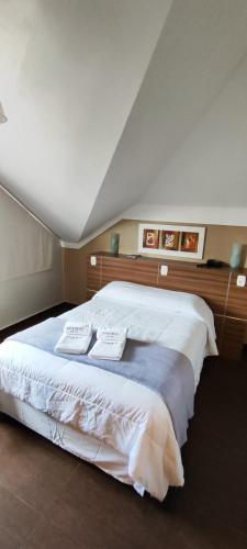 a bedroom with a bed with two pillows on it at Hotel Aguadero in Passo Fundo