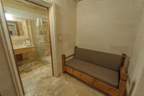 a bathroom with a bench in the corner of a shower at Zara Cave Hotel in Goreme