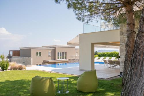 a backyard of a house with a swimming pool at Kempinski Villa 100m from Beach in Savudrija