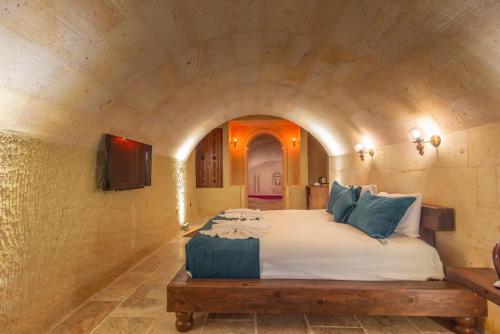 a bedroom with a large bed in a tunnel at Lagoon Cave Suites in Urgup