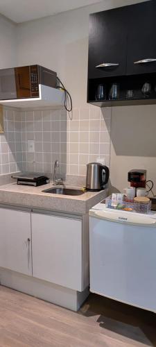 a kitchen with a sink and a counter top at STOP Mar Suite Privada - NI in Nova Iguaçu
