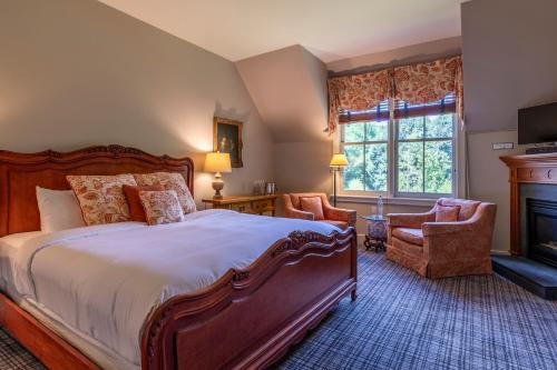 a bedroom with a large bed and a fireplace at The Jackson in Woodstock