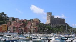 a bunch of boats in a harbor with a castle at Affittacamere La Baia Di Lerici in Lerici