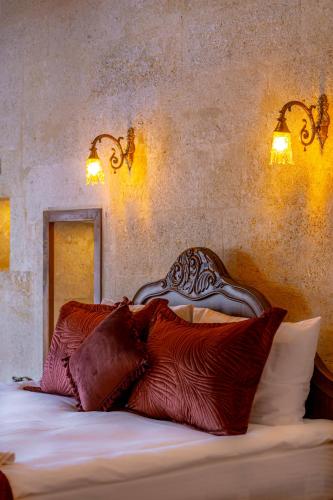 a bedroom with a bed with pillows on it at Lagoon Cave Suites in Urgup