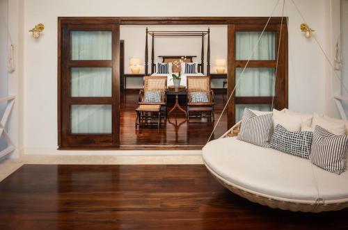 a living room with a swing in a room at Round Hill Hotel & Villas in Montego Bay