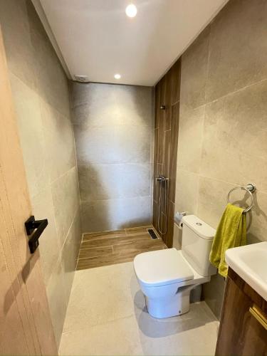 a bathroom with a toilet and a sink at Beachside Bliss: Cozy Surf Villa in Mirleft