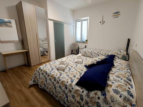a bedroom with a bed with blue pillows at Riserva-La marea in Vasto
