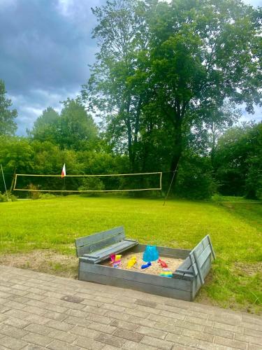 a sandbox with toys in it in a park at Domki pod Wolinem in Wolin