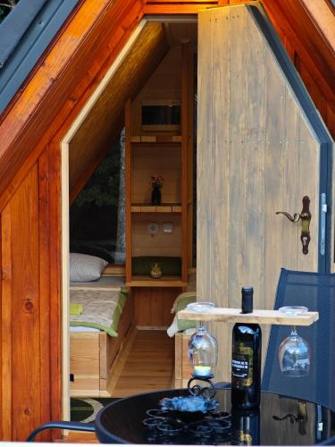 a small cabin with a bed and a sink in it at AirWood Glamping in Križe