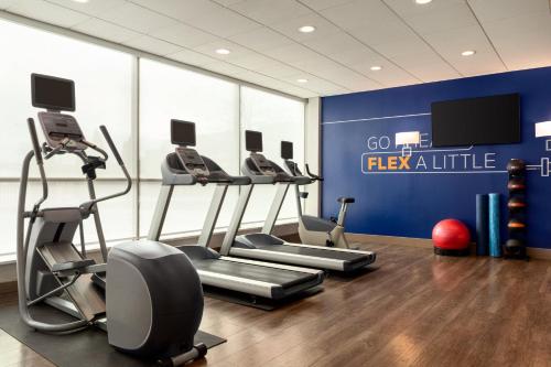 a gym with exercise equipment and a blue wall at Holiday Inn Express Baltimore At The Stadiums by IHG in Baltimore