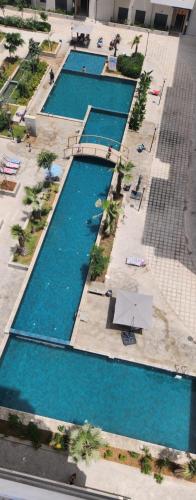 Πισίνα στο ή κοντά στο Ocean park , for married couples and families only , Luxury fully furnished one bedroom flat next to zenata beach with five avialable swimming pool at the compound