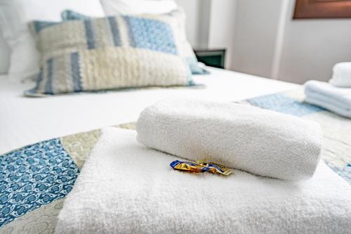 a white towel on a bed with a toy on it at Apartamentos San Roque en Llanes by megustarural in Llanes