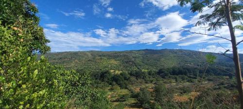 a view of a mountain with trees and a blue sky at San Rafael del Campo - Barichara in Barichara