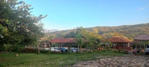 a house with a pool and mountains in the background at San Rafael del Campo - Barichara in Barichara