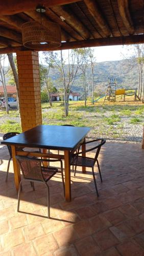 a picnic table and two chairs on a patio at San Rafael del Campo - Barichara in Barichara