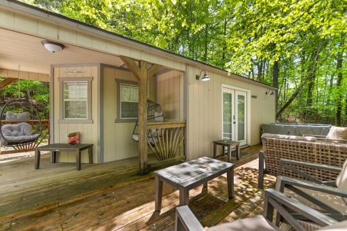 a screened in porch of a house with a table at SKYBRIDGE HILLTOP CABIN, COZY wd HOTTUB in Stanton