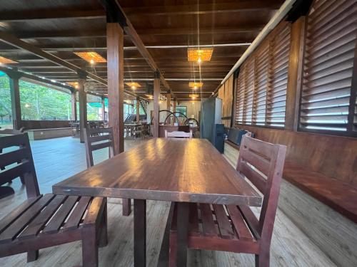 a wooden table and chairs in a room at Wilpattu Nature Resort in Murandanveli